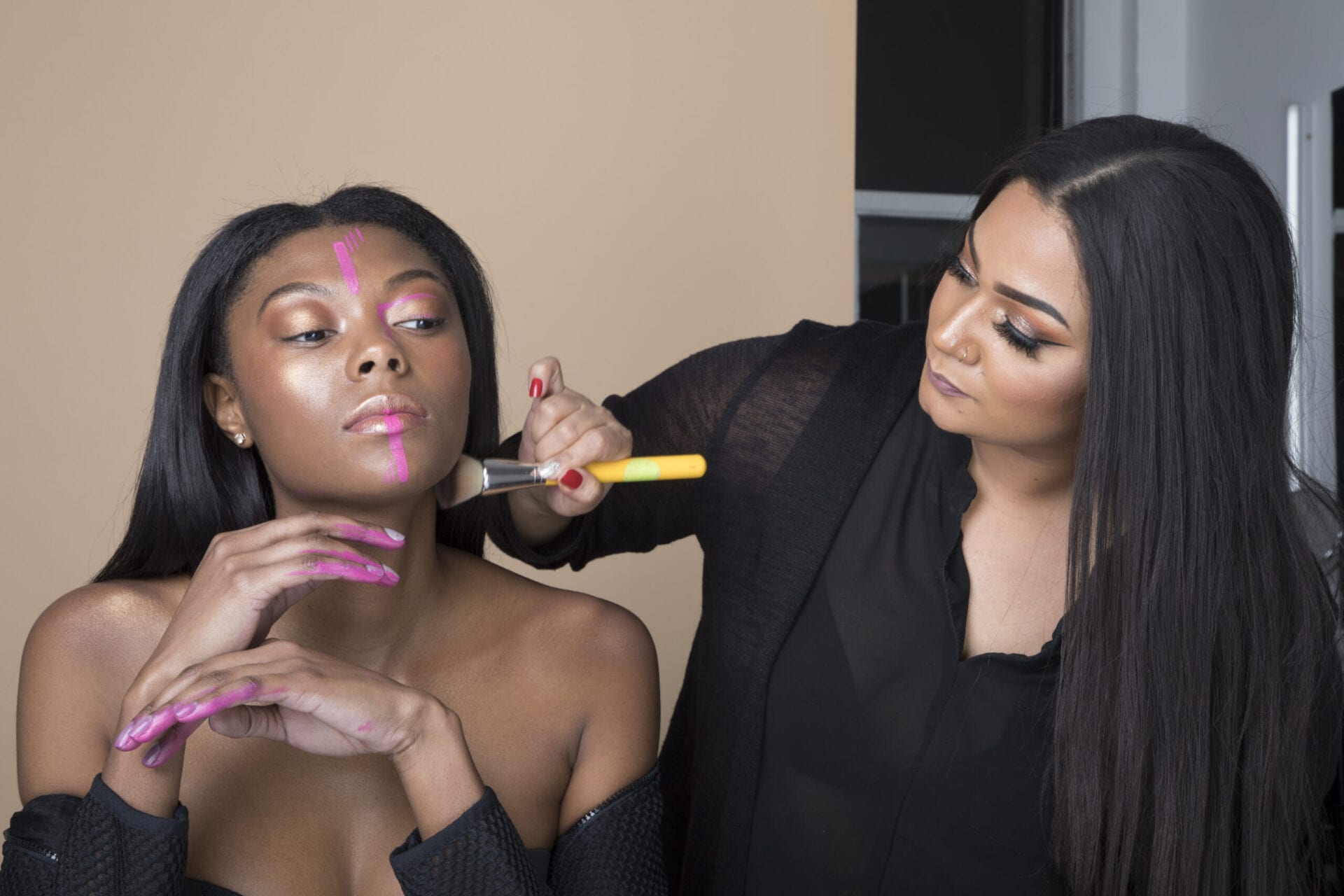 Roxie doing makeup on a model